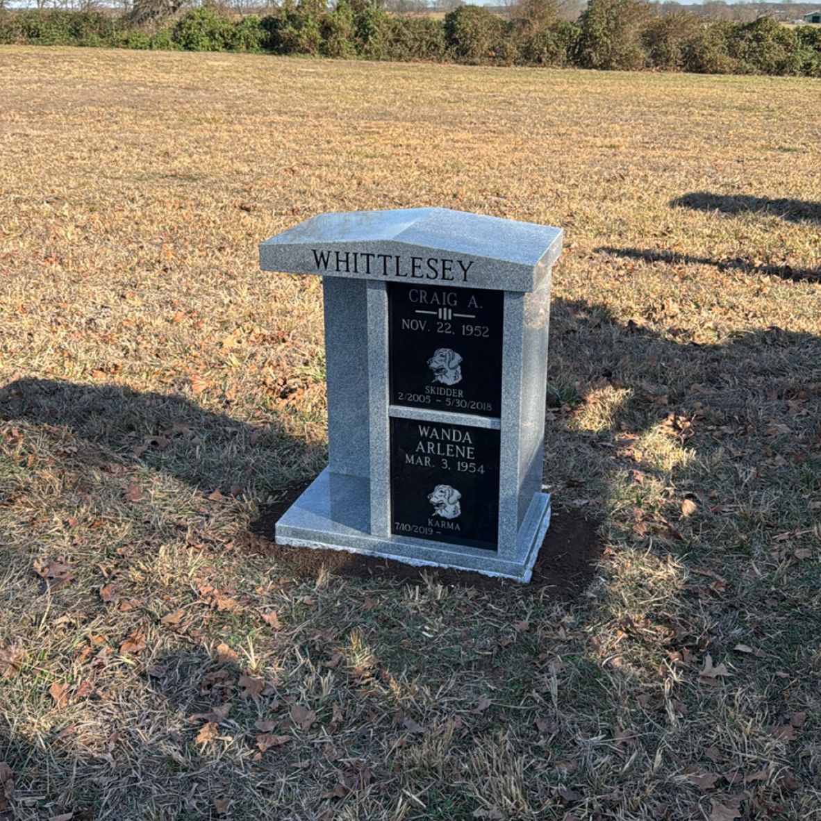 Emerson Monument Company The Tall Cremation Memorial in Gray Granite with Black Granite Doors in the cemetery