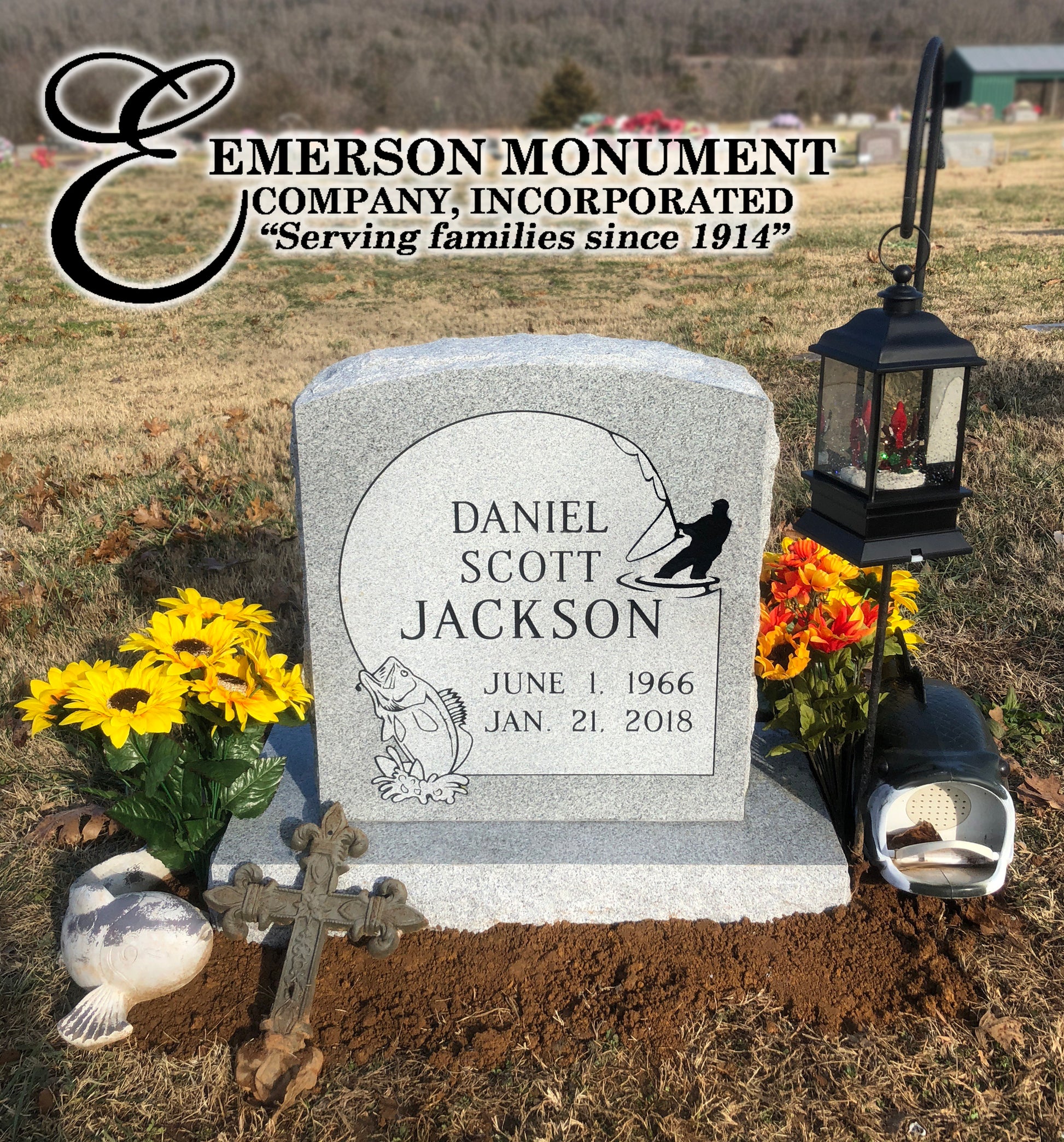 Emerson Monument Company small upright headstone in gray granite with fishing design